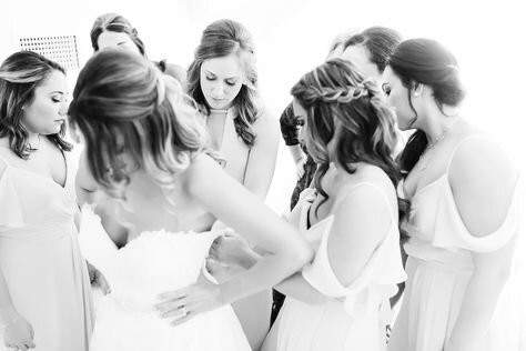 A bride surrounded by her bridesmaids