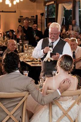 A person making a speech at a wedding reception