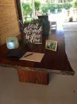 a guest book and photos on a wooden table