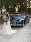 a bride standing in front of a classic Buick